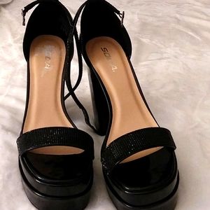 Platform shoes made by Soda, black in color, glossy shiny, and gorgeous, size 10